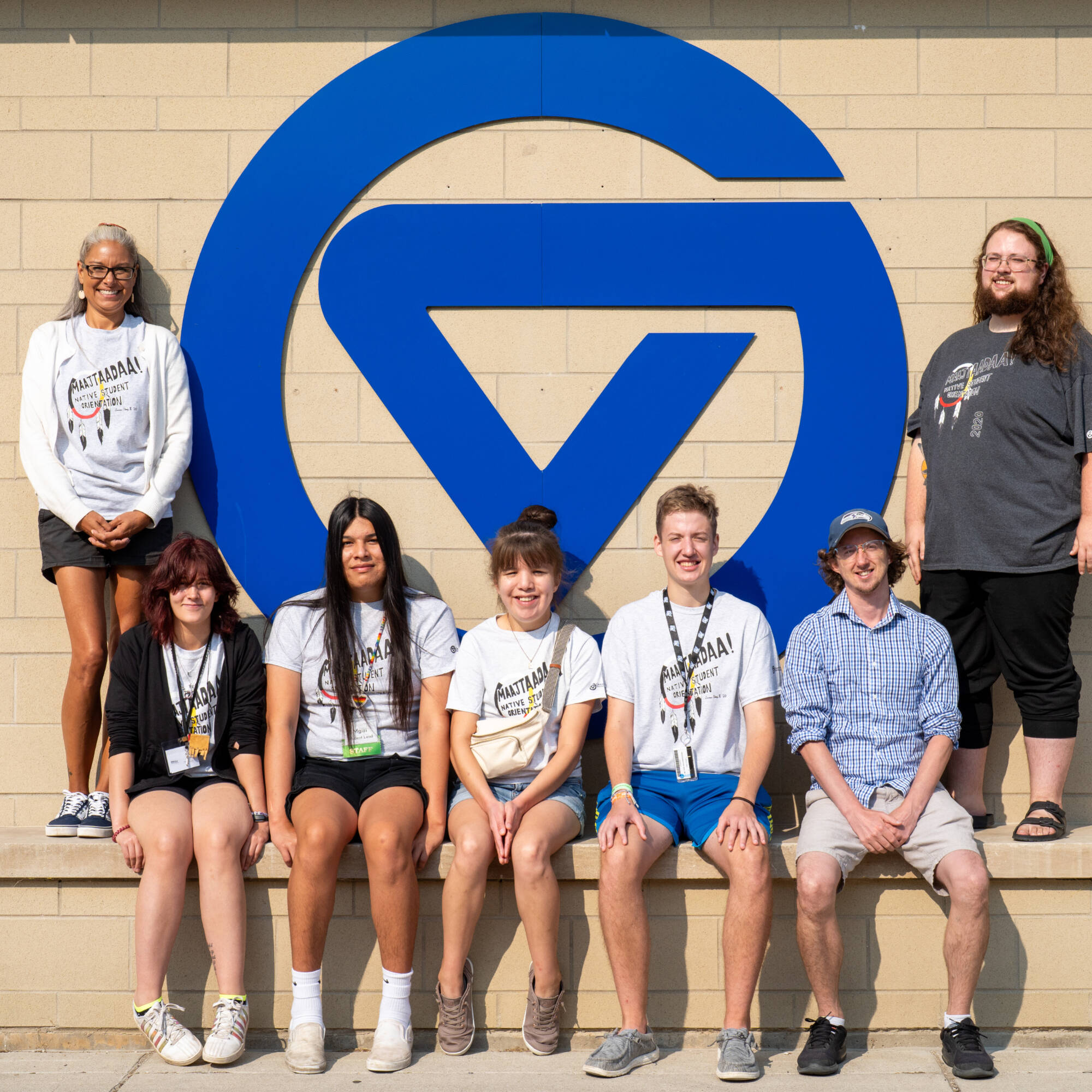Maajtaadaa students posing in front of the circle GV